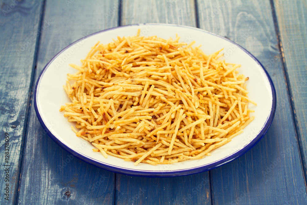potato chips on white plate on wooden background potato chips on white plate on wooden background