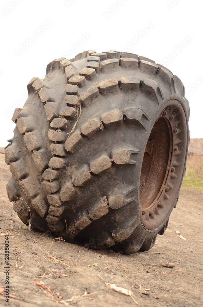 Big rubber wheel of the car on the sand Big rubber wheel of the car on the sand