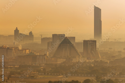 The hazy Dubai skyline over the Wafi Pyramids just after dawn in Dubai, UAE photo