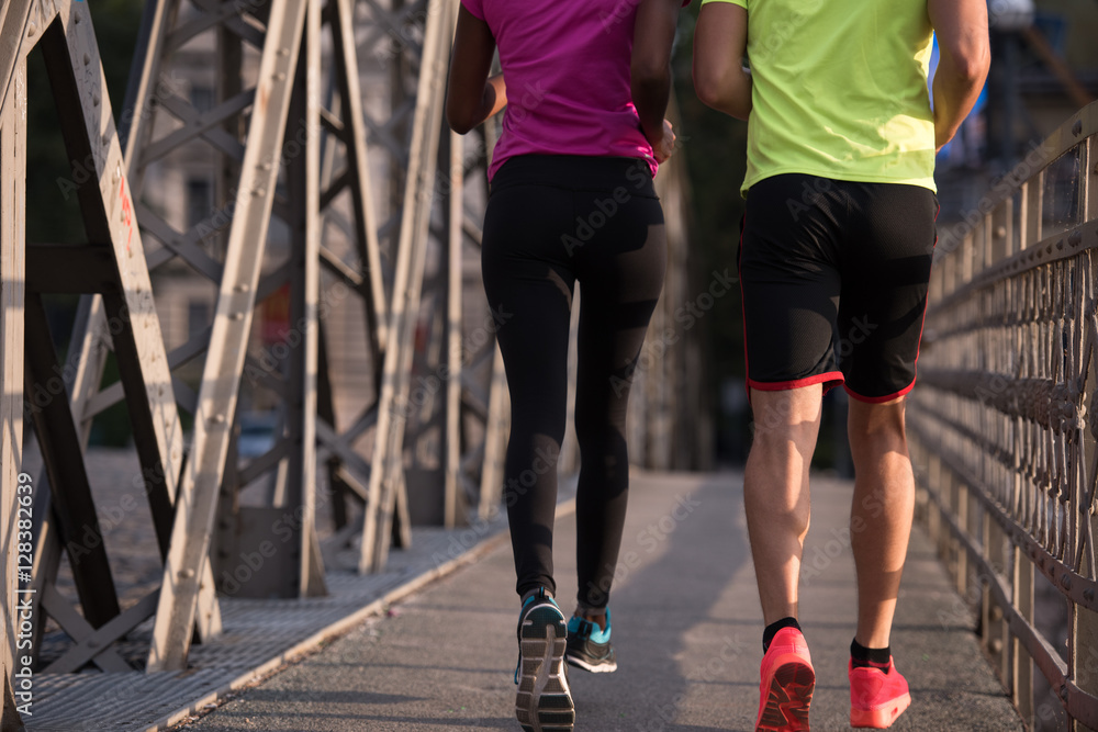 multiethnic couple jogging in the city multiethnic couple jogging in the city