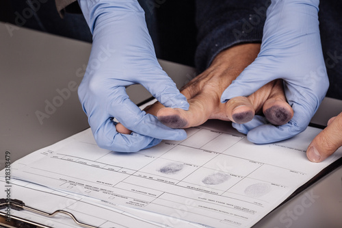 police takes fingerprints of a criminal