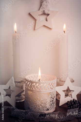 White candles and wood stars Christmas and New Year decoration in vintage style  toned
