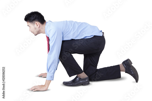 Businessman in ready position for competing