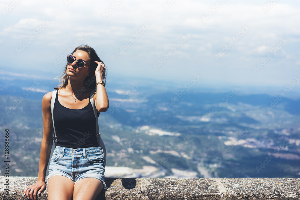 Hipster young girl with backpack and sunglasses looking on observation deck and planning travel plan. View tourist traveler on background panoramic view of the city mockup, summer in Barcelona Hipster young girl with backpack and sunglasses looking on observation deck and planning travel plan. View tourist traveler on background panoramic view of the city mockup, summer in Barcelona
