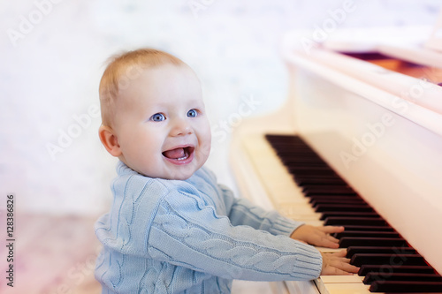 cute laughing baby playing the piano