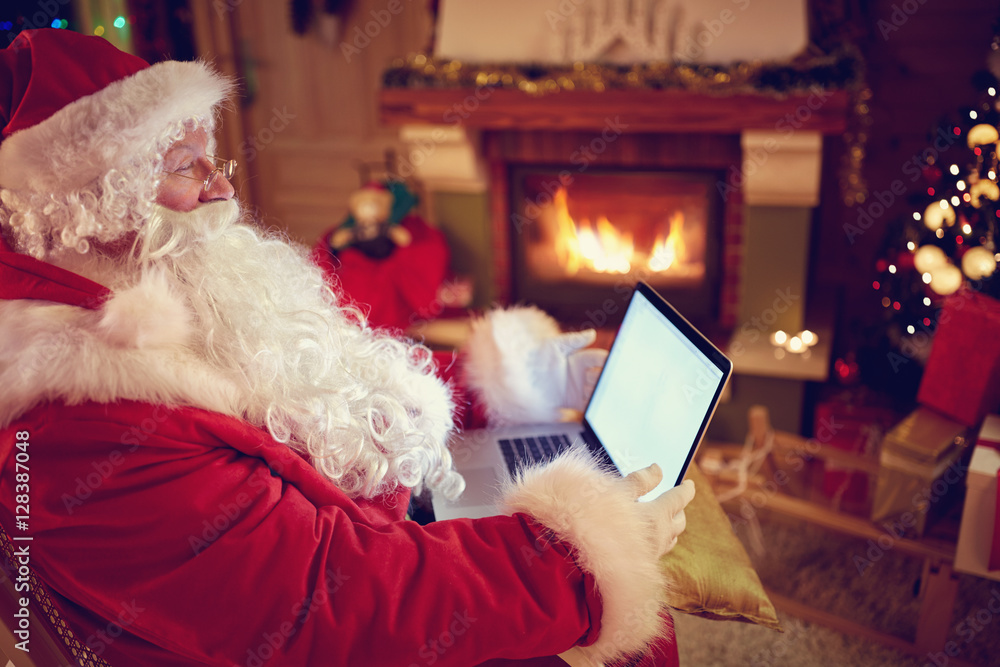 Real Santa Claus using new technology for communication with chi Real Santa Claus using new technology for communication with chi