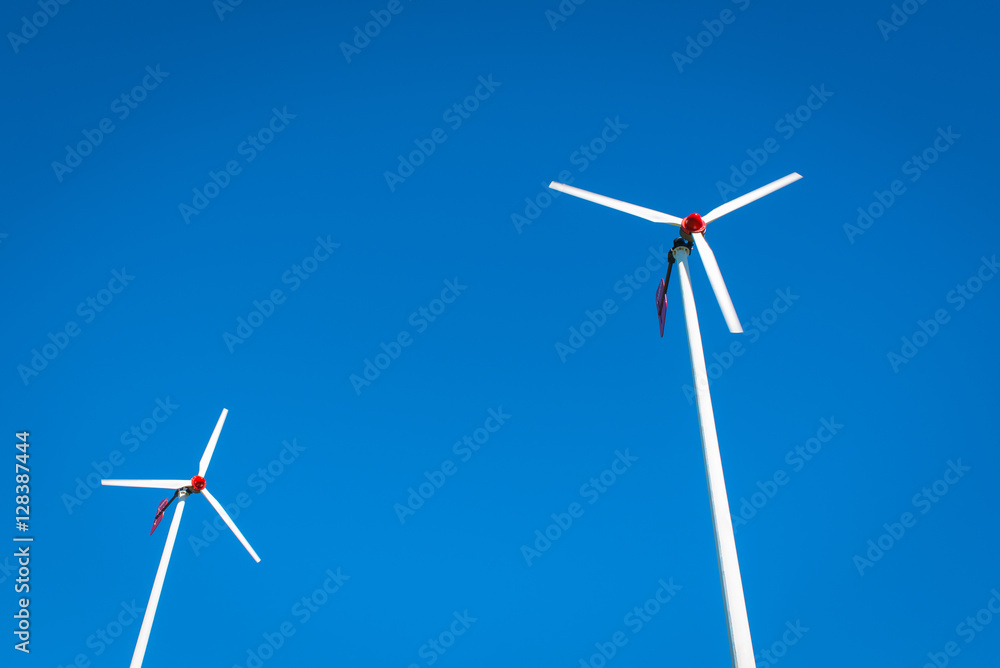 Two Wind turbines with blue sky background with copy space Two Wind turbines with blue sky background with copy space