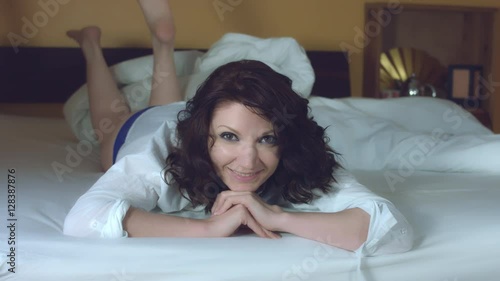 4k Morning Shot of a Sexy Woman Smiling at Camera in her Bed photo