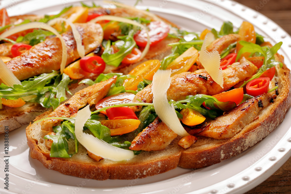 Chicken sandwich on fresh bread with arugula tomato and cheese Chicken sandwich on fresh bread with arugula tomato and cheese