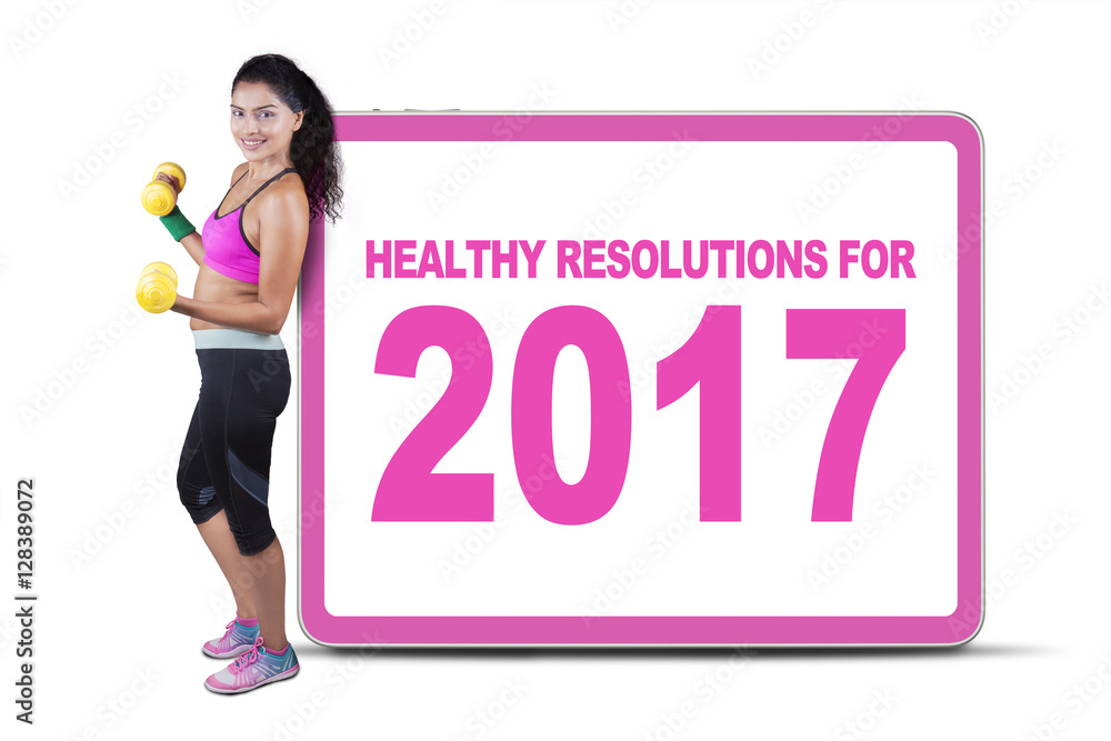 Obraz premium Woman holding dumbbells with a board