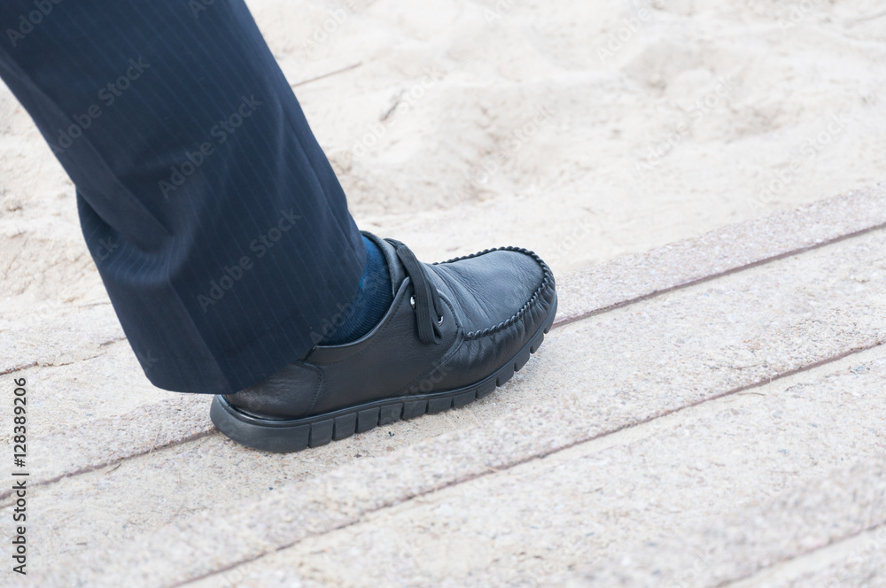 closeup view of man's leather black shoes,Businessman walking to the office closeup view of man's leather black shoes,Businessman walking to the office