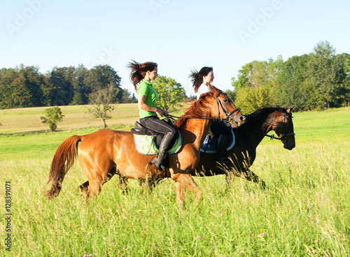 Two Women Horseback Riding in a Landscape