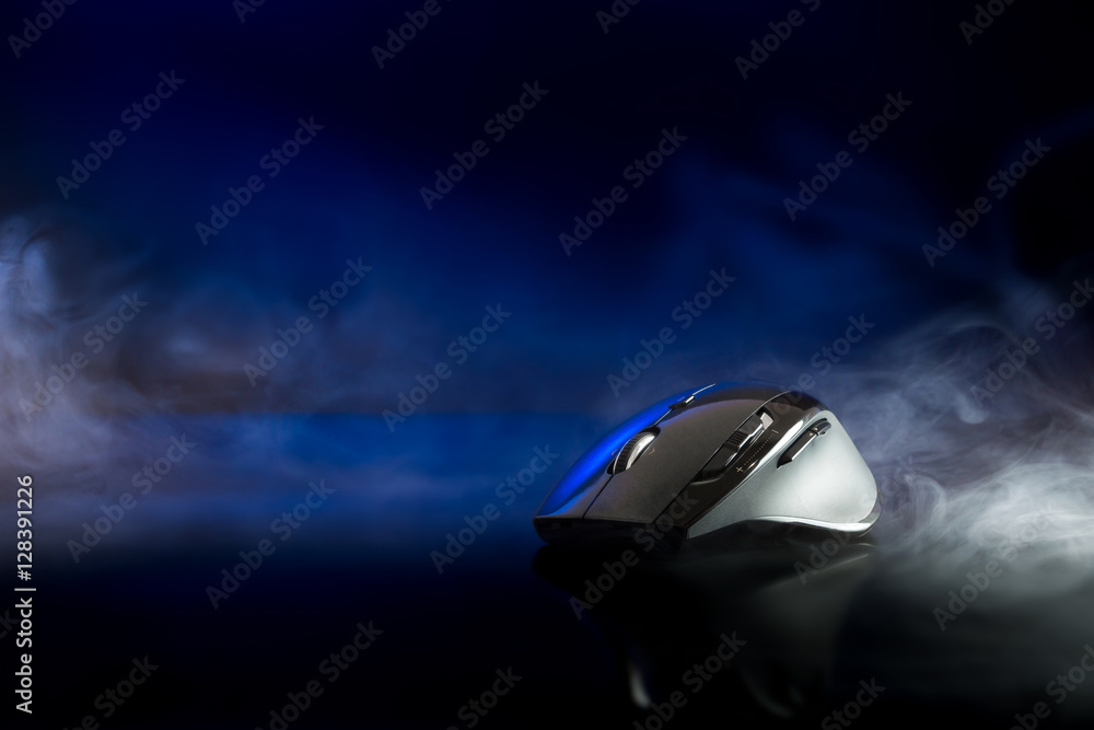 High technology computer gaming mouse in dark blue tone with smoke High technology computer gaming mouse in dark blue tone with smoke
