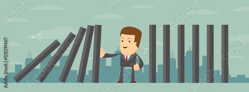Man stopping the domino effect with falling dominoes