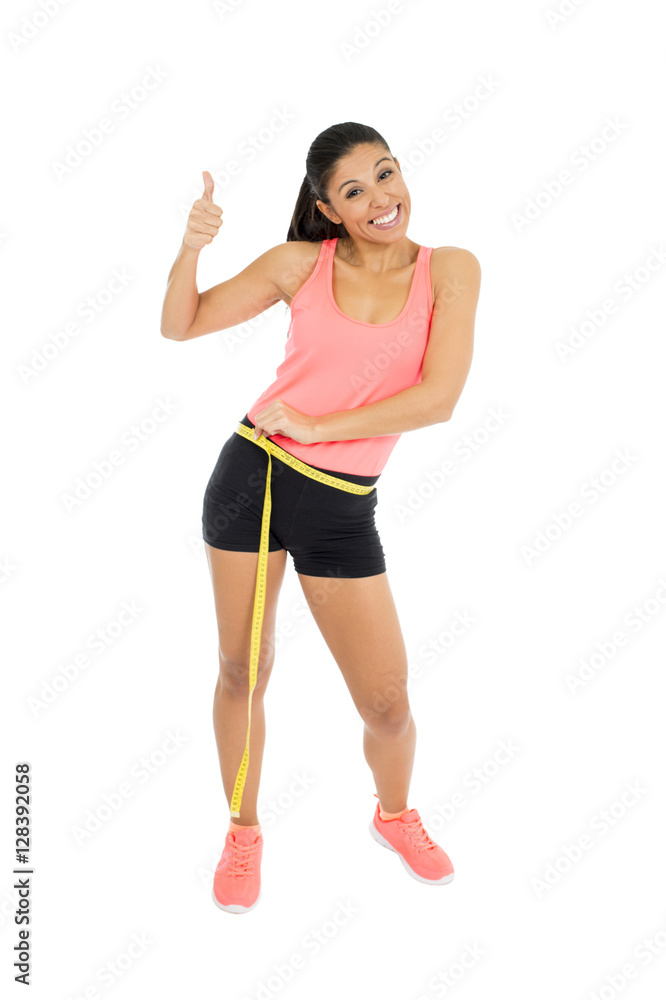 beautiful latin woman in fitness clothes measuring body waist size holding measure tape smiling happy beautiful latin woman in fitness clothes measuring body waist size holding measure tape smiling happy