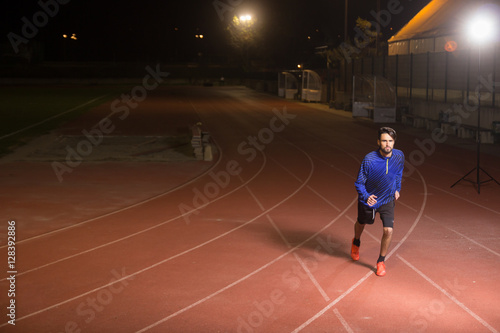runner, running tracks dark night time. © HD92