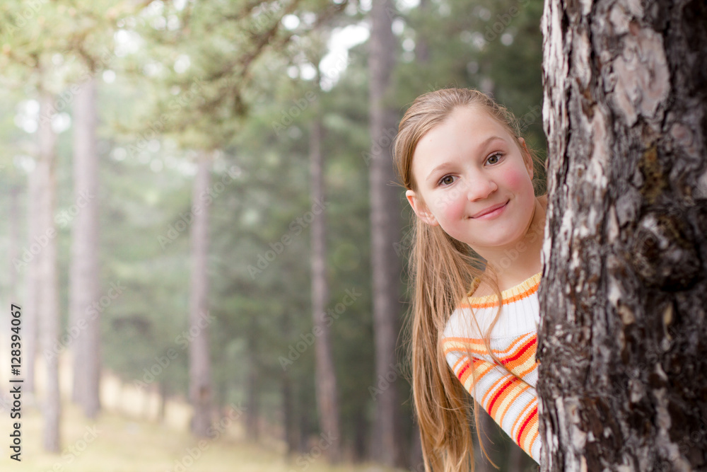 Little girl hiding behind the tree Little girl hiding behind the tree