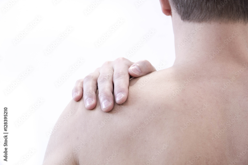 healthcare and problem concept - unhappy man suffering from neck or shoulder pain at home