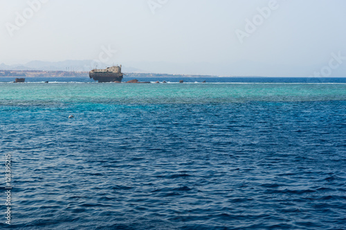 View on the old broken ship in the blue sea
