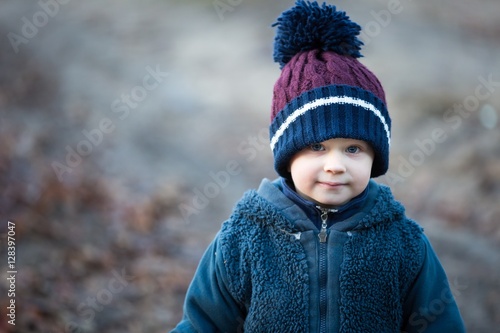 Handsome caucasian boy portrait in autumnal light.