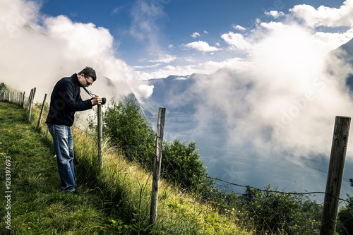 Young photographer is taking a picture in Norway photo