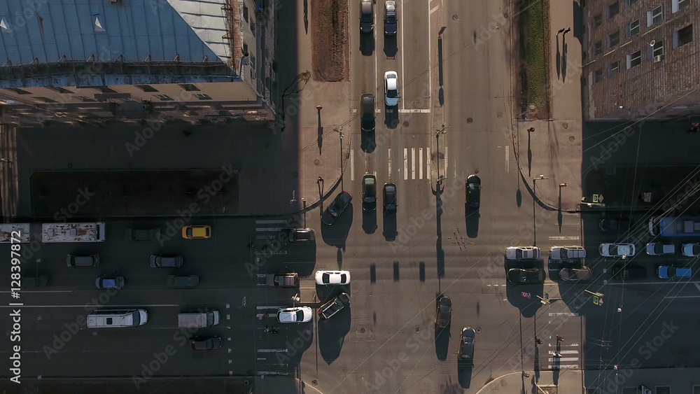 Evening crossroads in the city, cars drive through the bright part of the road, aerial view. St. Petersburg, Russia Evening crossroads in the city, cars drive through the bright part of the road, aerial view. St. Petersburg, Russia