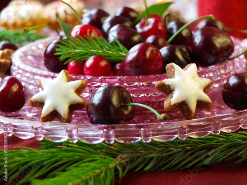 Christmas dessert with star gingerbread, fruits and twig tree