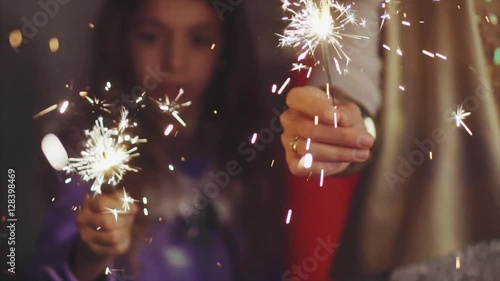 Close up family hands with sparklers lights in christmas eve HD