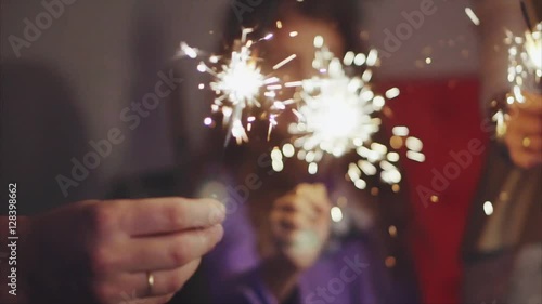 Close up family hands with sparklers lights in christmas eve HD