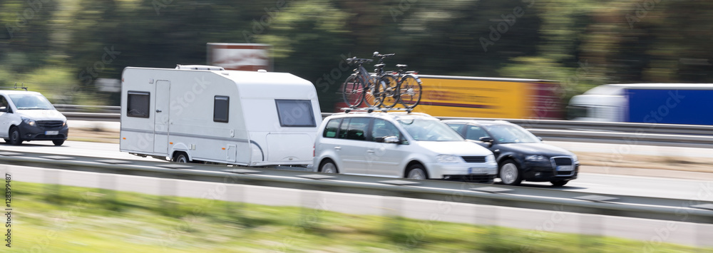 car with a caravan highway speed blur - obrazy, fototapety, plakaty 