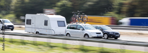 Fotografie, Tablou car with a caravan highway speed blur