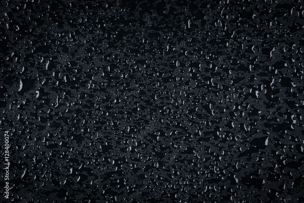 Water drops on dark stone surface Water drops on dark stone surface