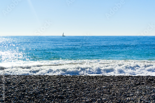 Waves breaking on a beach, forming sprays