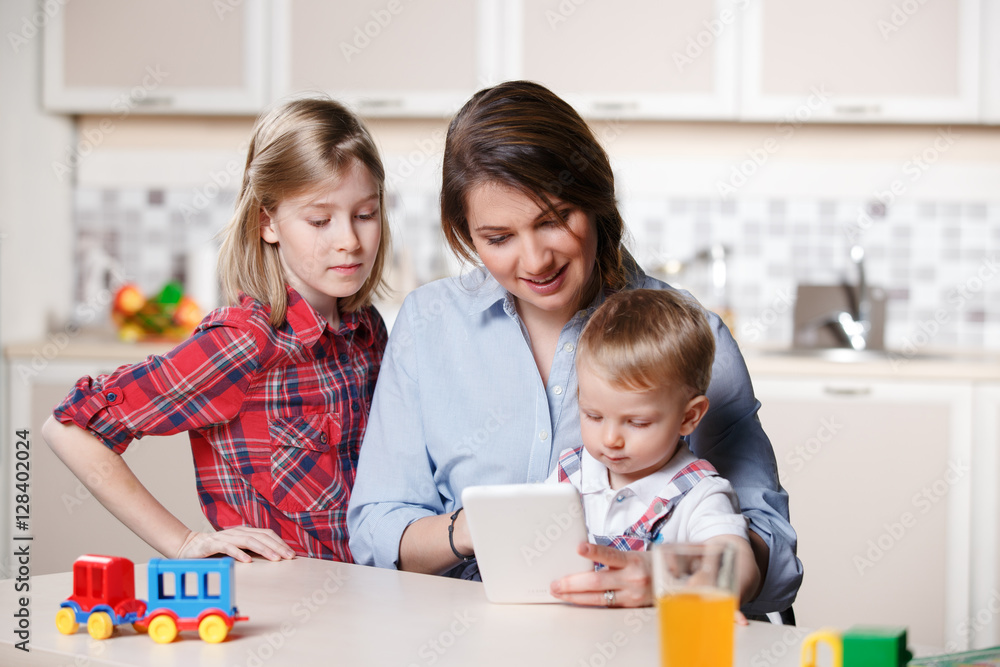 young mom playing with her little toddler son and sister at home young mom playing with her little toddler son and sister at home