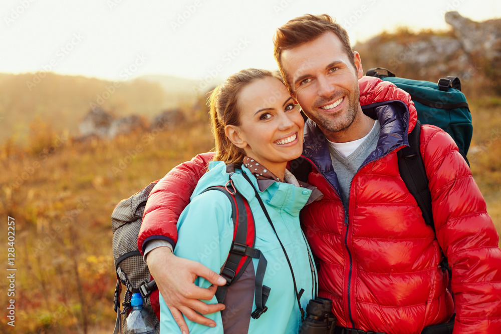 © baranq - Happy couple hiking during autumn, fall with backpacks