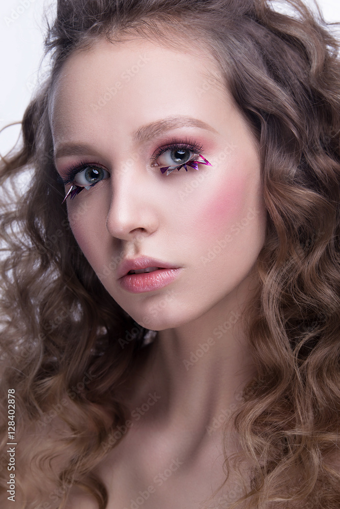 Close-up portrait of beautiful woman with bright makeup and wavy hairstyle. Fashion shiny highlighter on skin, gloss lips makeup. Close-up portrait of beautiful woman with bright makeup and wavy hairstyle. Fashion shiny highlighter on skin, gloss lips makeup.