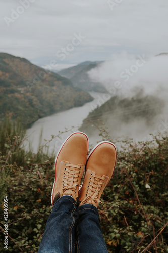 boots in the foreground on the panoramic view of the Valley, concept of adventure and travel