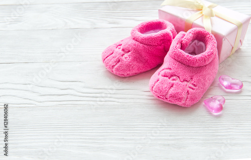 pink baby's bootees on wooden background © 279photo