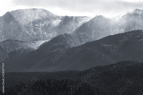 Bilde på lerret Powerful winds with snow and blowing snow obscure magnificent Pikes Peak Colorado on a blustery early winter day