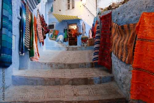 Street full of carpets in Chefchaouen, Morocco © juanorihuela