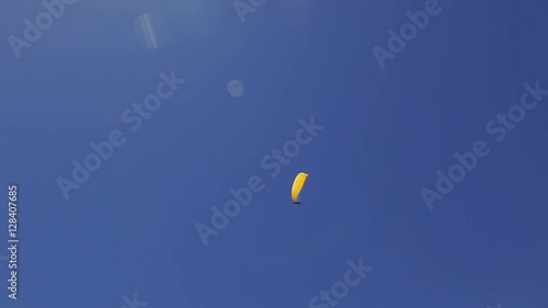 paragliding over the Alps mountains against blue sunny sky