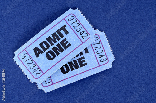 Two pair blue admit one ticket stub for movie or theater isolated on a blue background photo photo