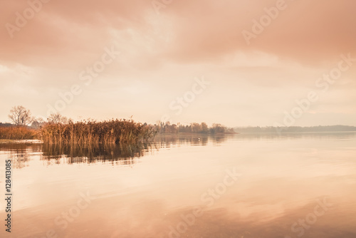 Sunrise on the quiet lake and reeds