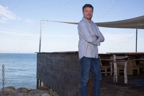 Portrait of handsome man standing with arms crossed