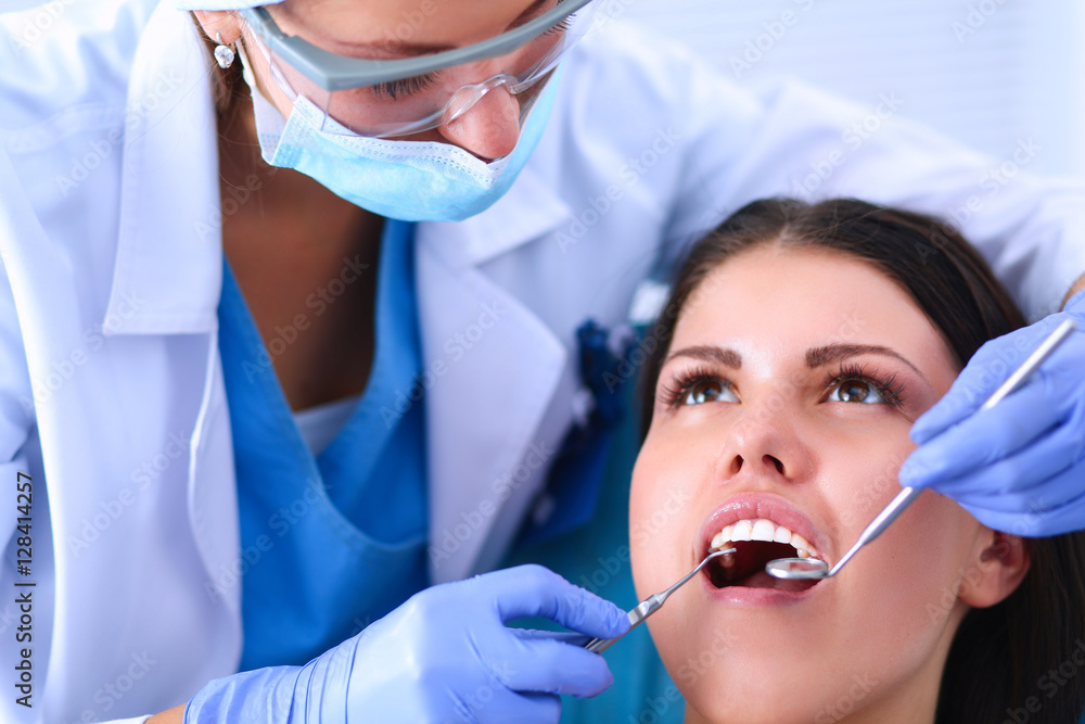 Woman dentist working at her patients teeth Woman dentist working at her patients teeth