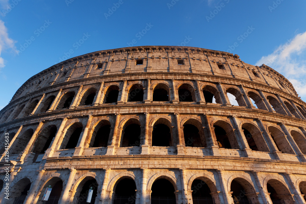 Wide view of the Roman Colosseum with a blue sky 