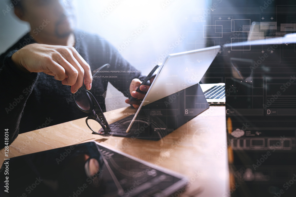 Website designer holding eyeglasses and working digital tablet d Website designer holding eyeglasses and working digital tablet d