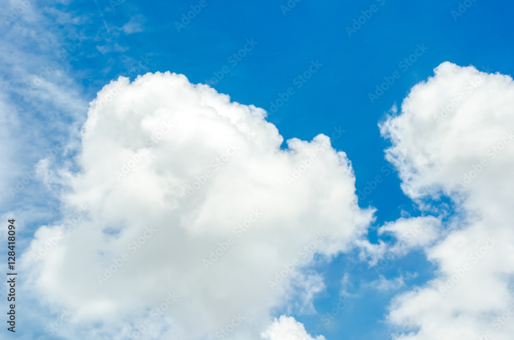 Looking up at Big white cloud and light ray behind cloud with bl