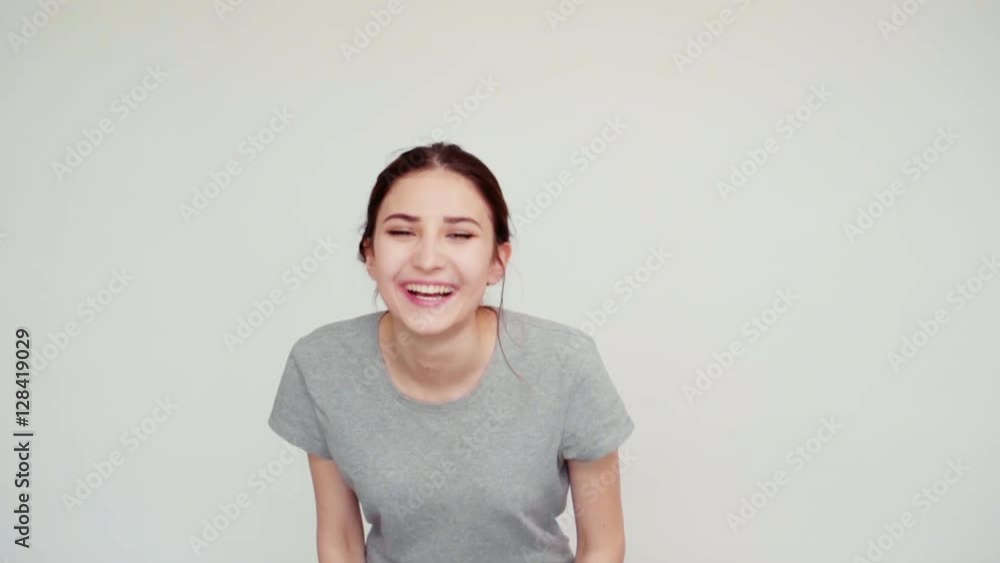 Portrait girl 14 years old teenager on the white background. Teen looking at camera and laughing. Slow motion from SonyA6300 Portrait girl 14 years old teenager on the white background. Teen looking at camera and laughing. Slow motion from SonyA6300