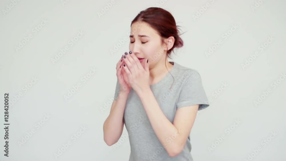 Portrait sad girl 14 years old sneezes and looking at camera on white background. Slow motion from Sony A6300 Portrait sad girl 14 years old sneezes and looking at camera on white background. Slow motion from Sony A6300